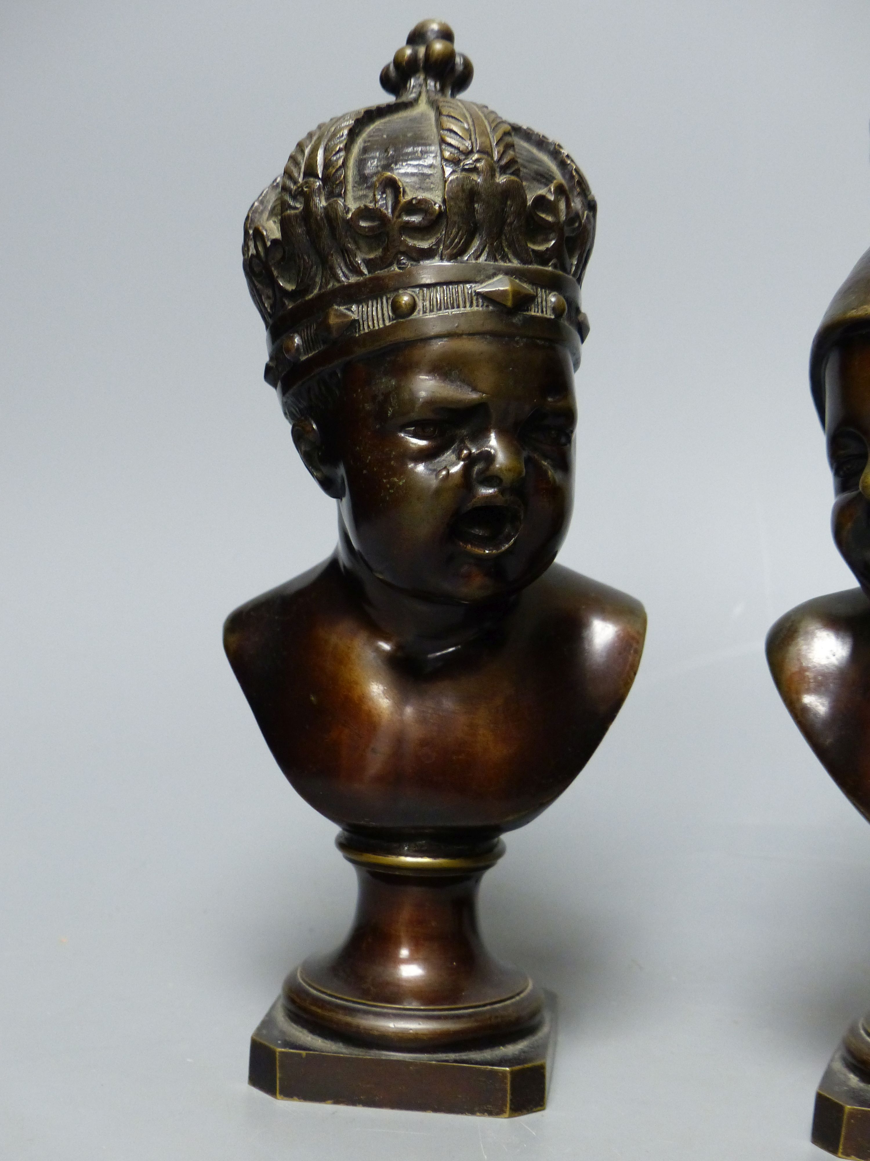 A small bronze bust of a child wearing a crown and another small bronze bust of a child, tallest 22cm H 22cm